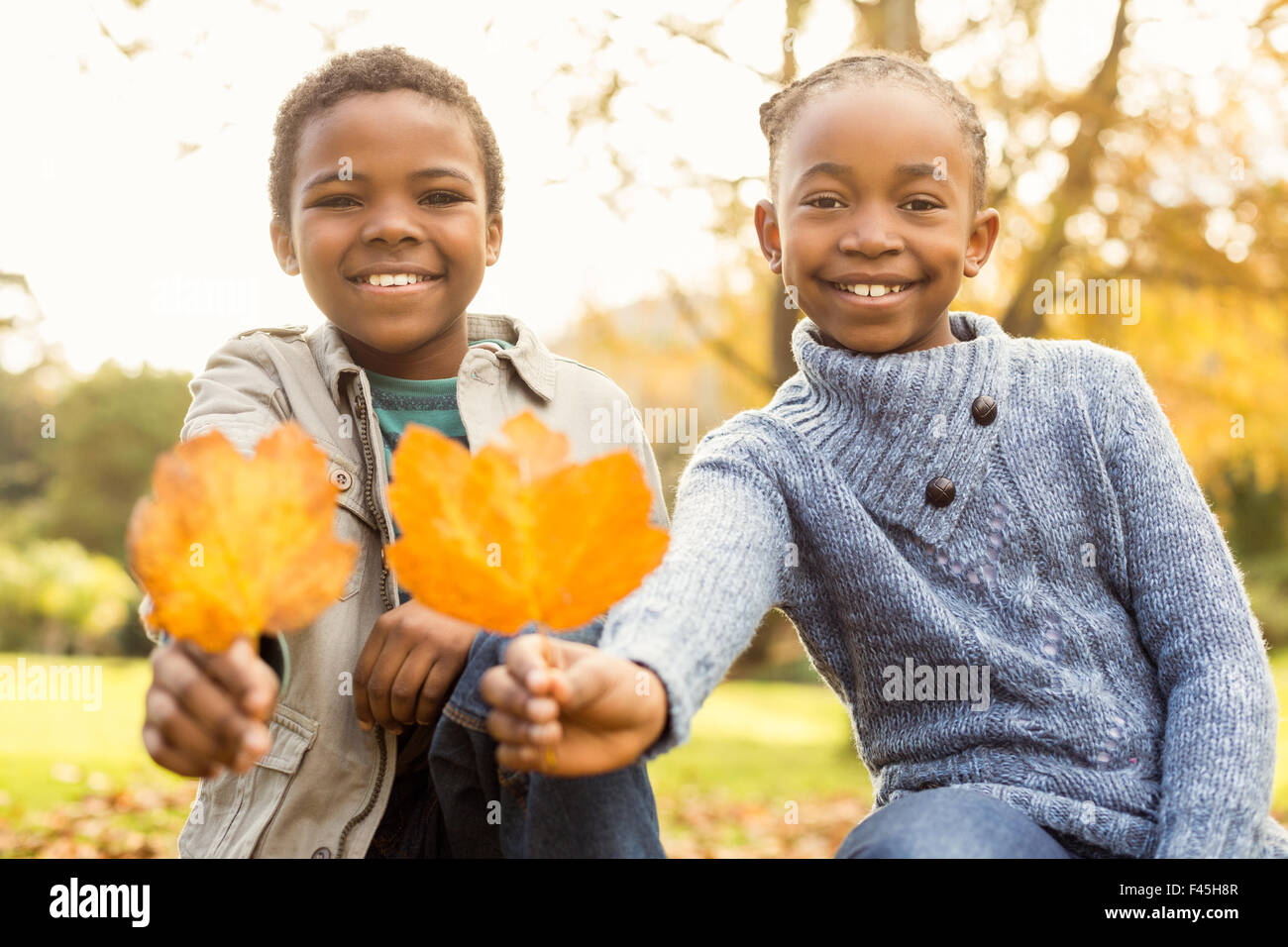 Portrait of young children holding leaves Stock Photo