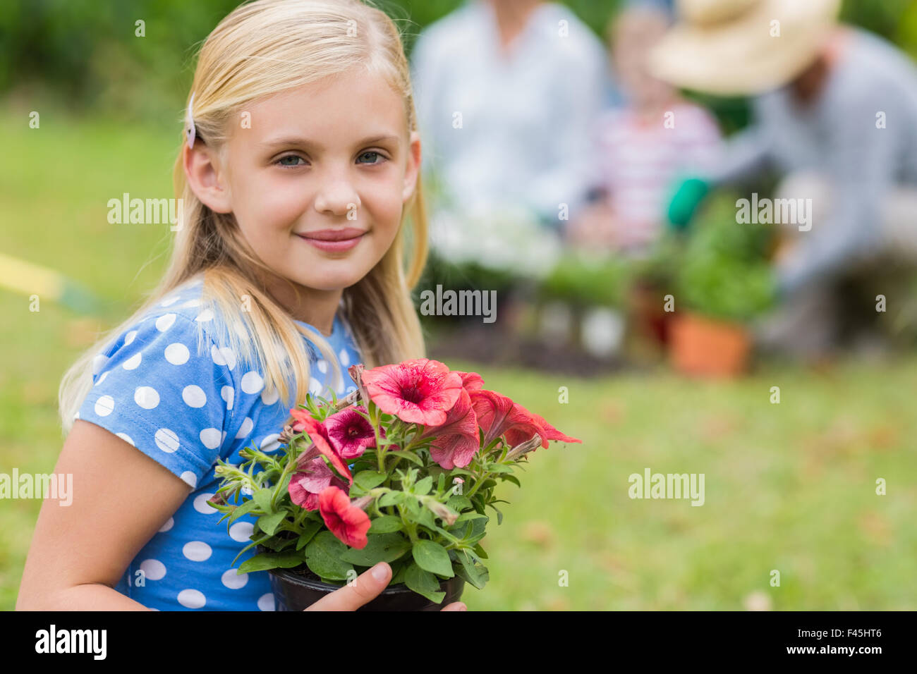 Young girl sitting with flower pot Stock Photo - Alamy