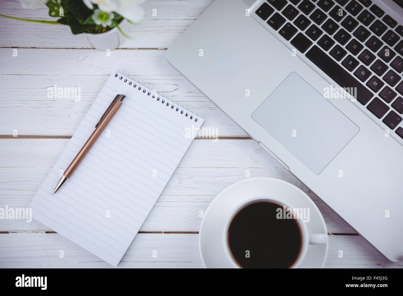 Overhead shot of laptop and notepad Stock Photo - Alamy