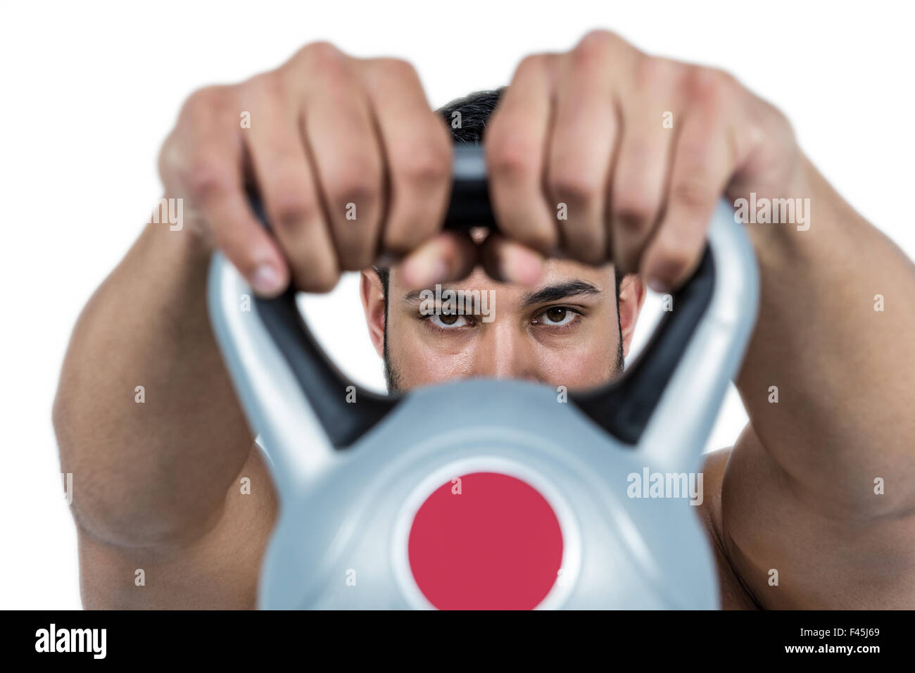 Muscular man lifting heavy kettlebell Stock Photo Alamy