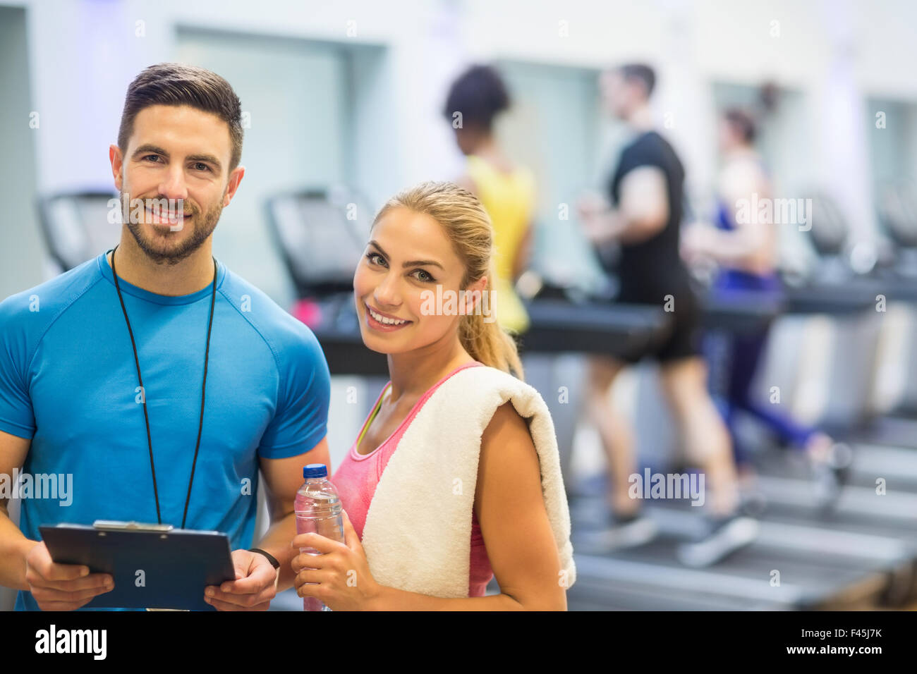 Trainer And Client Trainer and client discussing her progress Stock Photo - Alamy