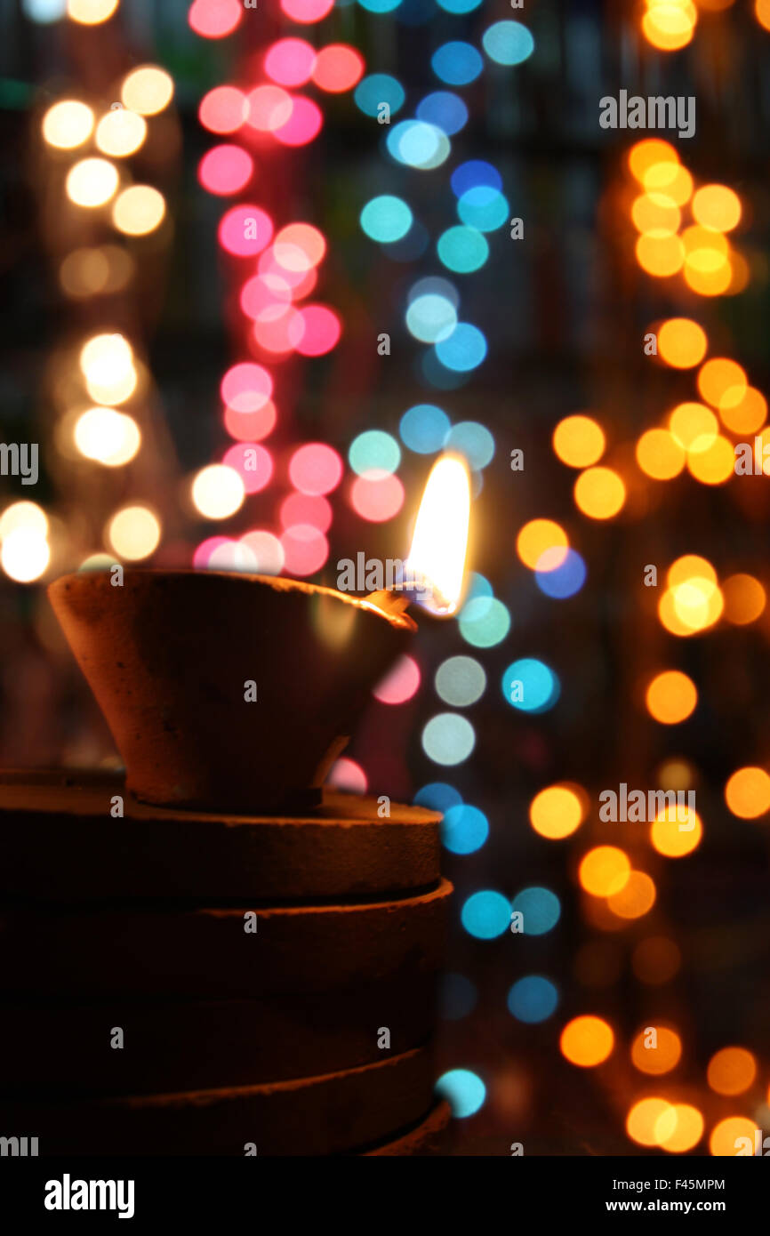 Traditional Diwali lamps in colorful blur festive lights during ...