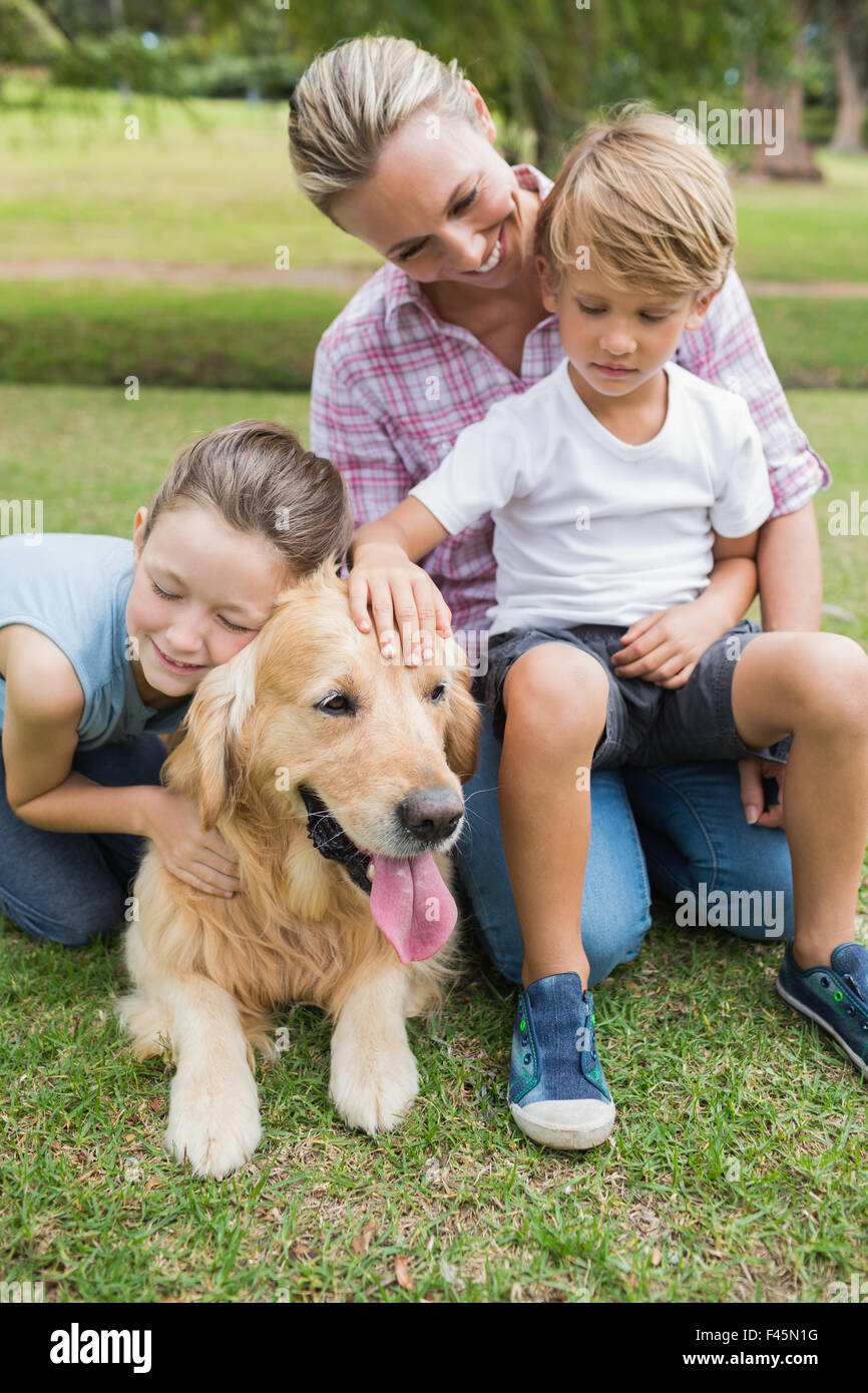 Happy family in the park with their dog Stock Photo