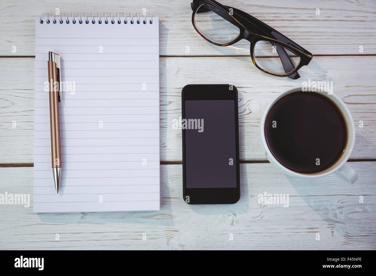 Overhead shot of notepad and smartphone Stock Photo - Alamy