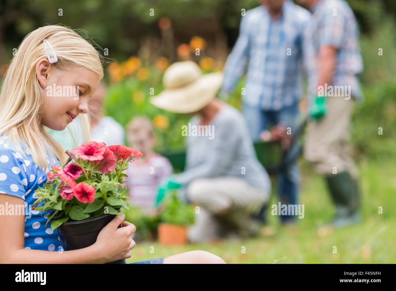 Young girl sitting with flower pot Stock Photo - Alamy