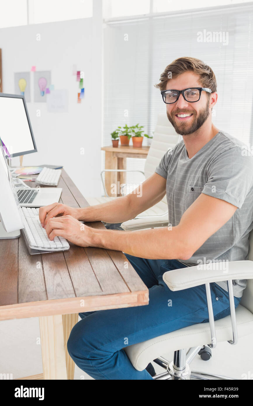 Handsome businessman sitting on a swivel chair and using his laptop ...