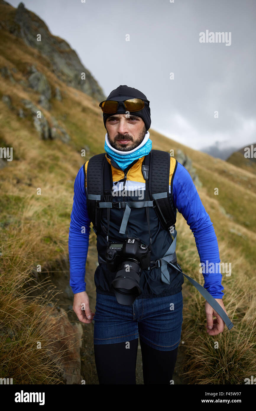 Caucasian man with backpack hiking into the mountains Stock Photo - Alamy