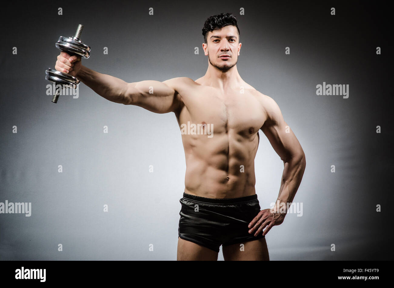 Muscular ripped bodybuilder with dumbbells Stock Photo - Alamy