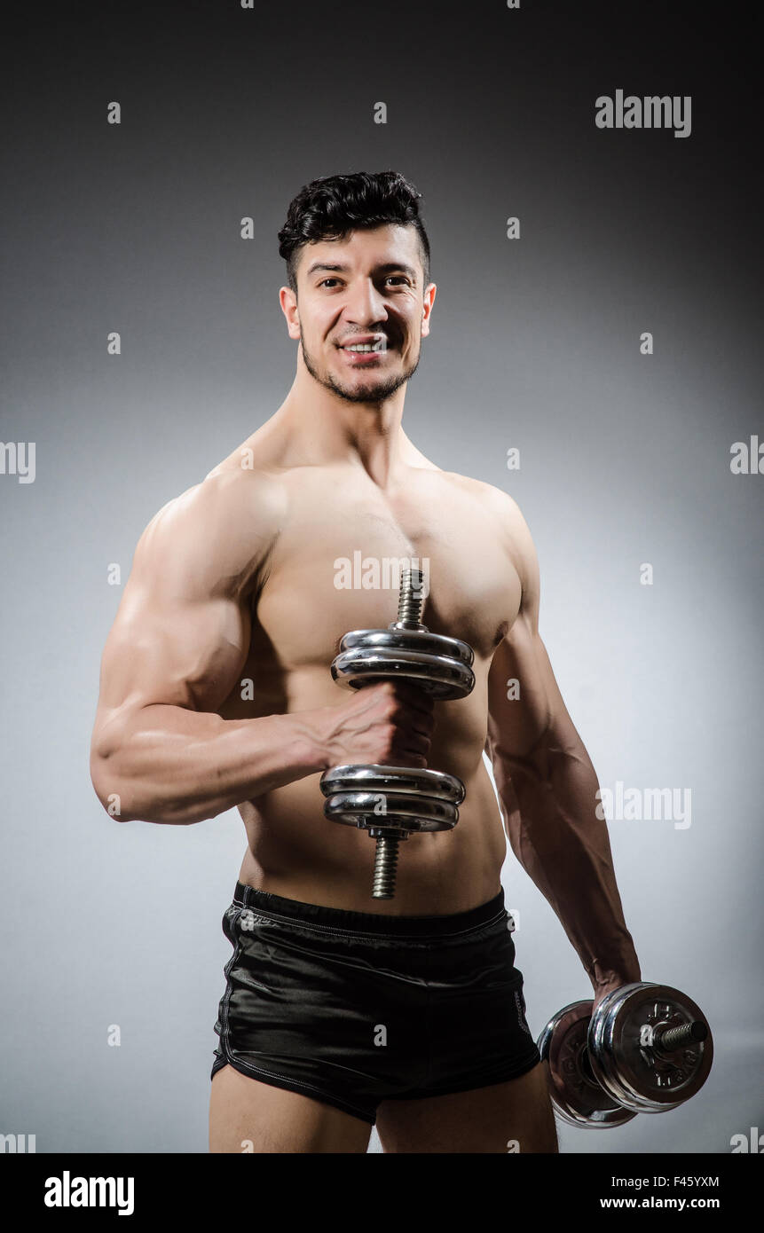Muscular ripped bodybuilder with dumbbells Stock Photo - Alamy