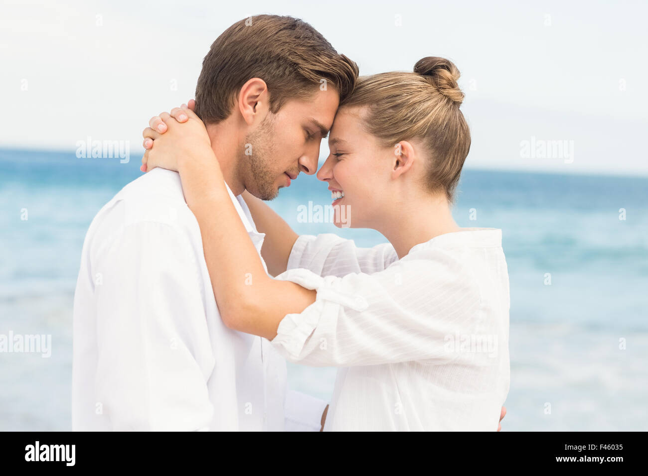 Happy couple hugging and smiling at each other Stock Photo - Alamy