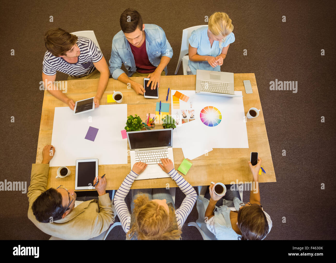 Creative team with laptop and digital tablet Stock Photo - Alamy