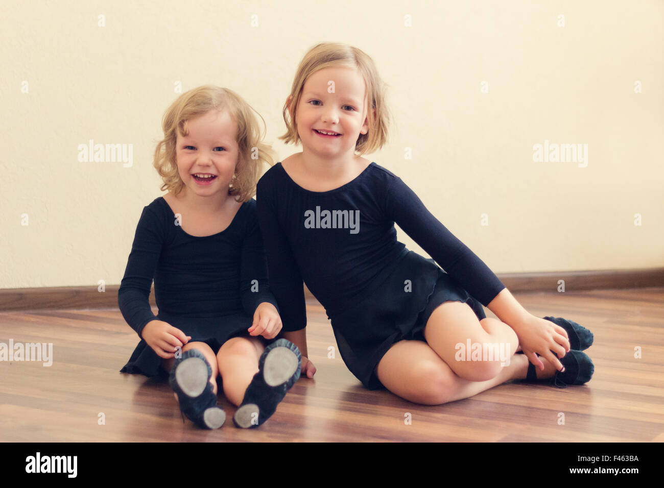 Funny little girls (sisters) - dancer. Selective focus. Stock Photo