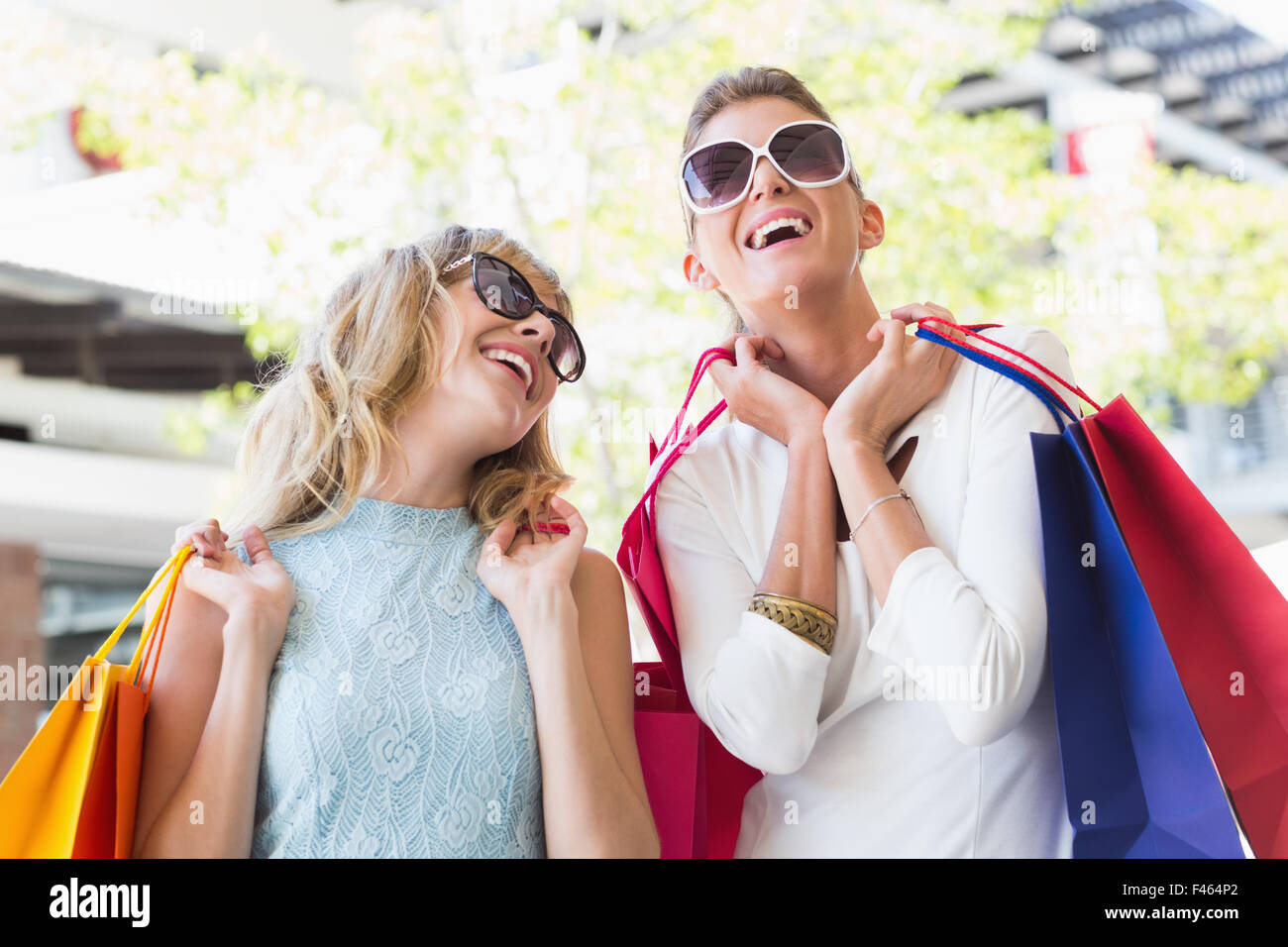 Beautiful women holding shopping bags Stock Photo - Alamy
