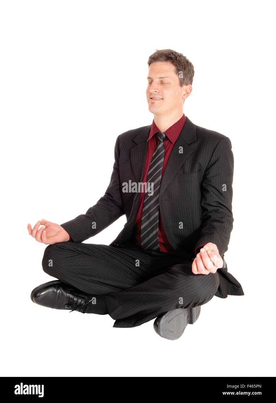 Businessman doing yoga Stock Photo - Alamy