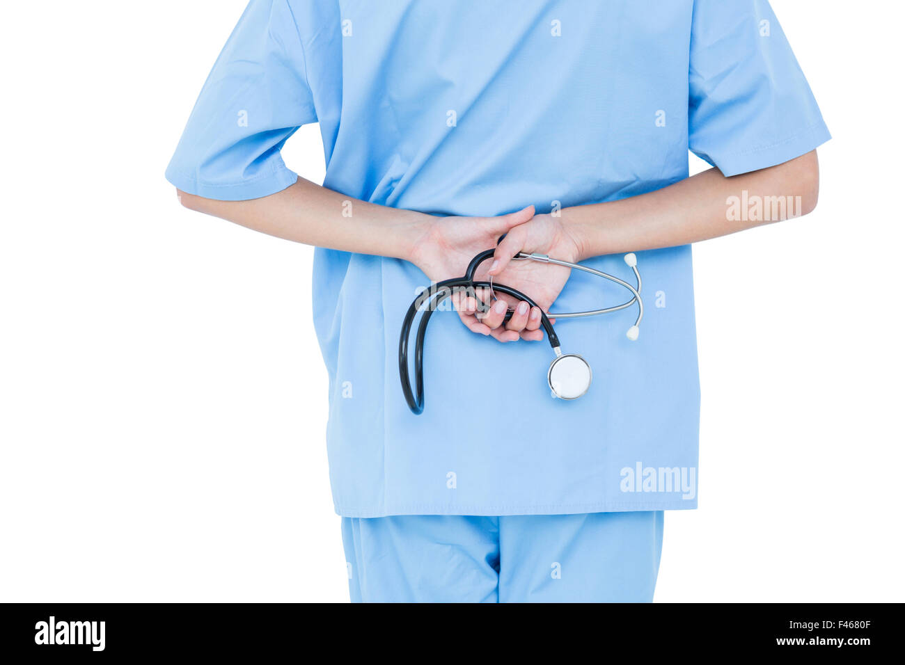 Concentrated doctor standing with stethoscope Stock Photo