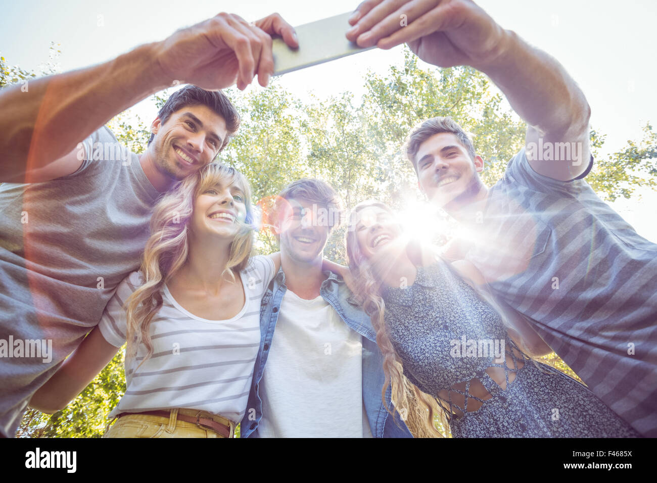 Happy friends in the park taking selfie Stock Photo - Alamy
