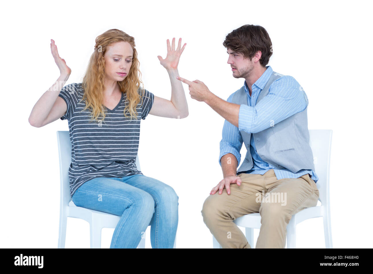 Sitting couple having an argument Stock Photo - Alamy