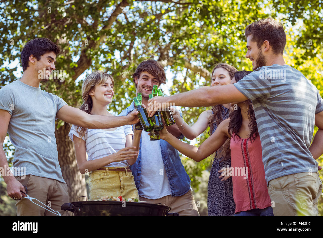 Happy friends in the park having barbecue Stock Photo - Alamy