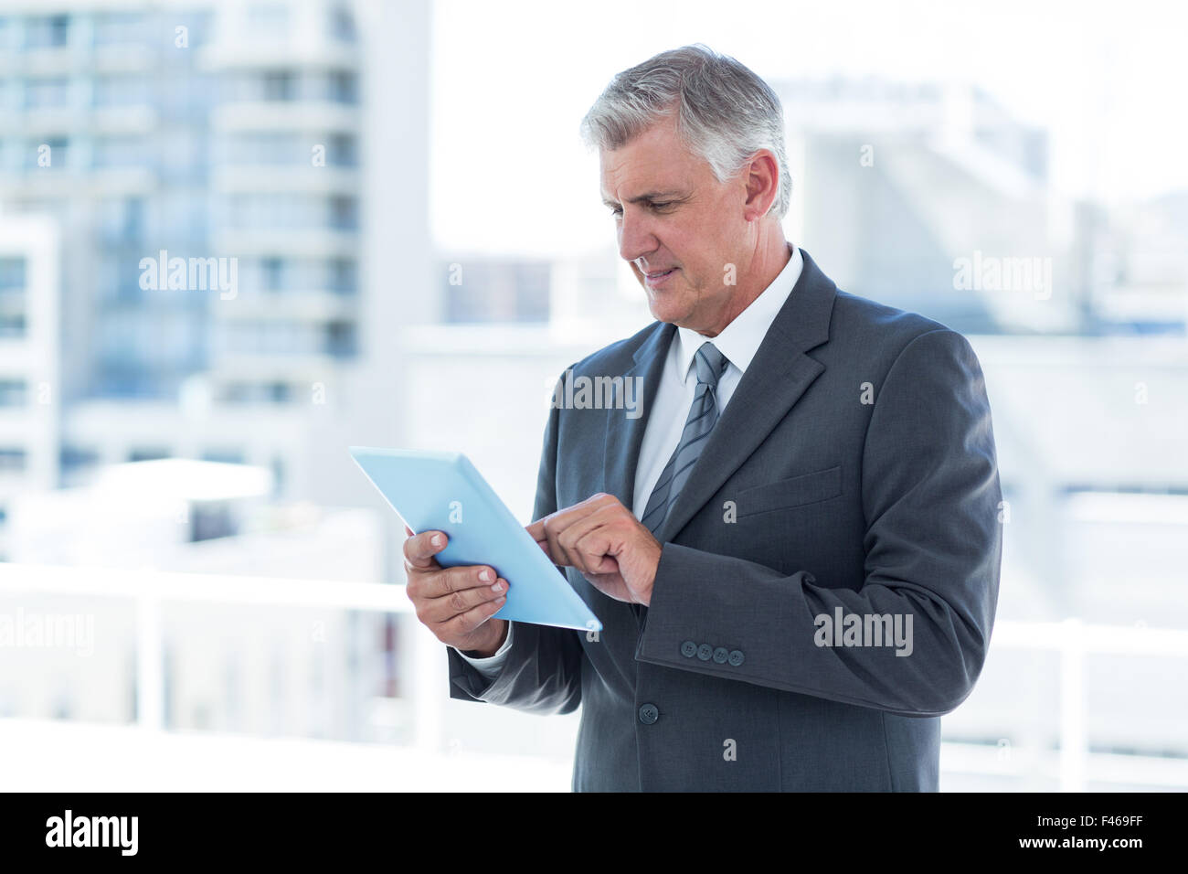 Businessman using his tablet Stock Photo - Alamy