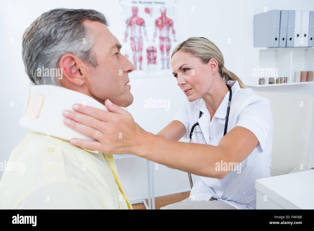 Doctor examining patient wearing neck brace Stock Photo Alamy