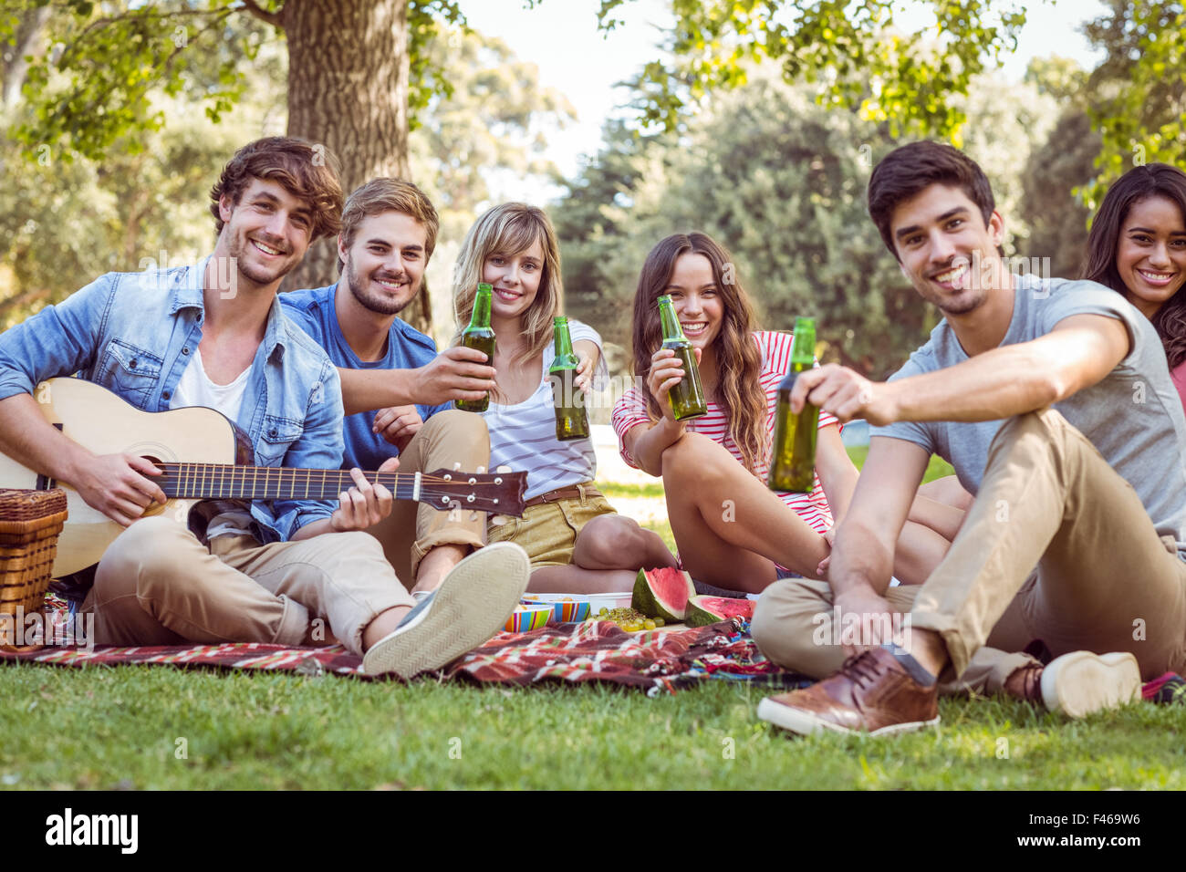 Happy friends in the park having picnic Stock Photo - Alamy