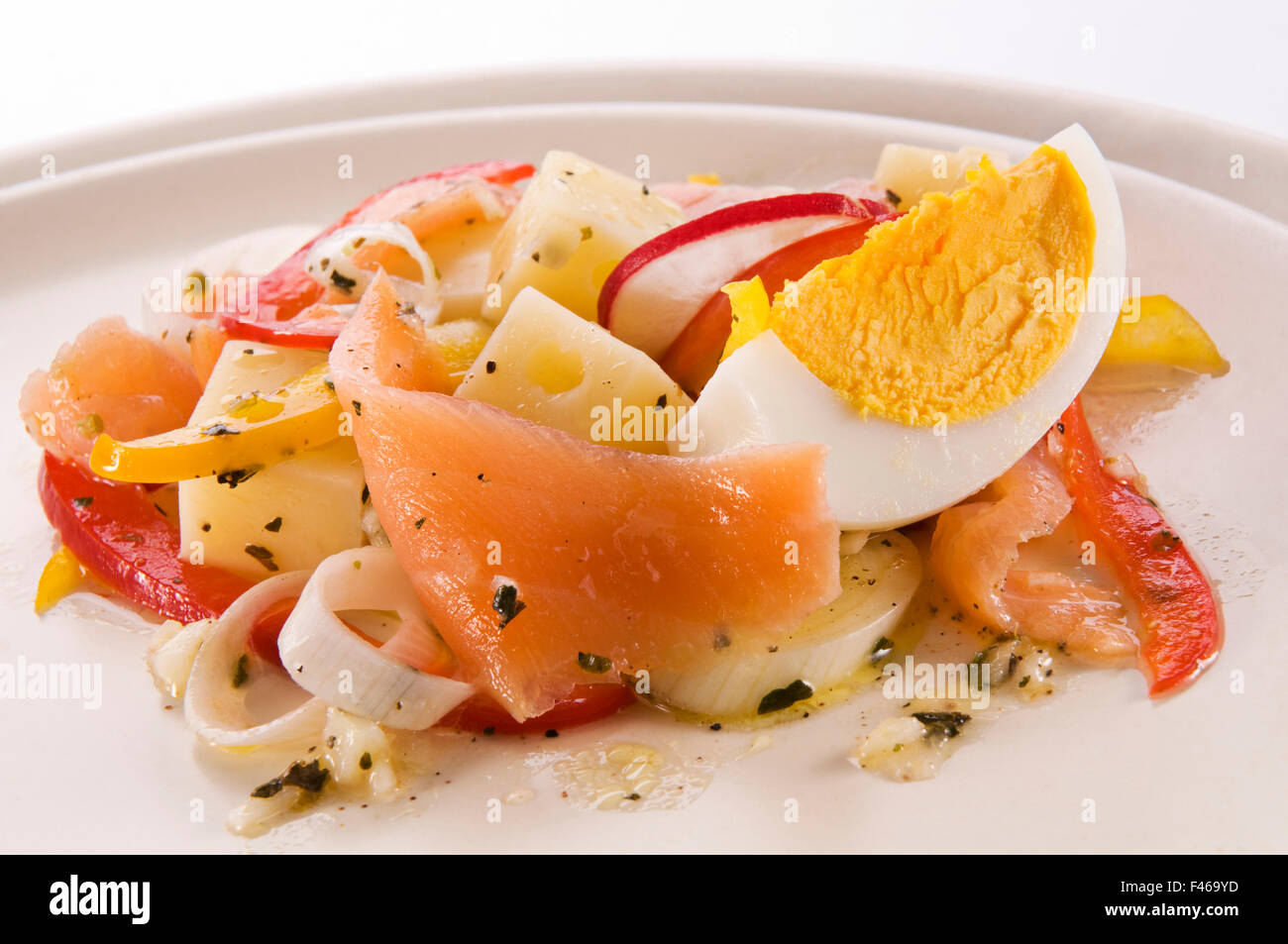 Appetizer of fresh salmon with cheese and vegetables close up. Stock Photo