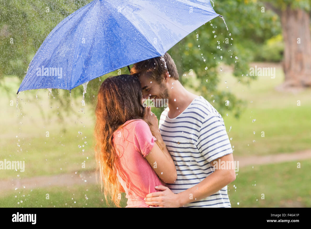 Cute couple hugging under the umbrella Stock Photo - Alamy