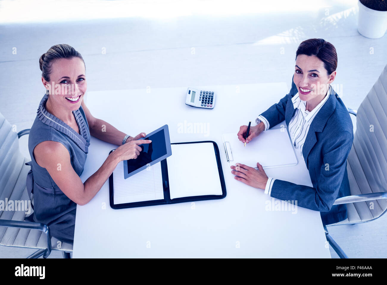 Businesswomen working together at desk Stock Photo - Alamy
