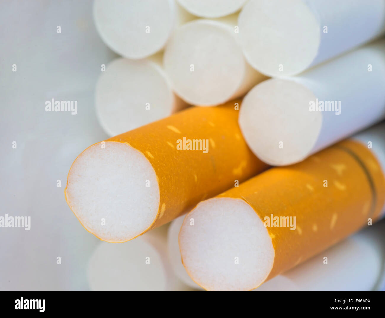 Medicine concept. Cigarettes with a yellow filter lie on a white surface  Stock Photo - Alamy