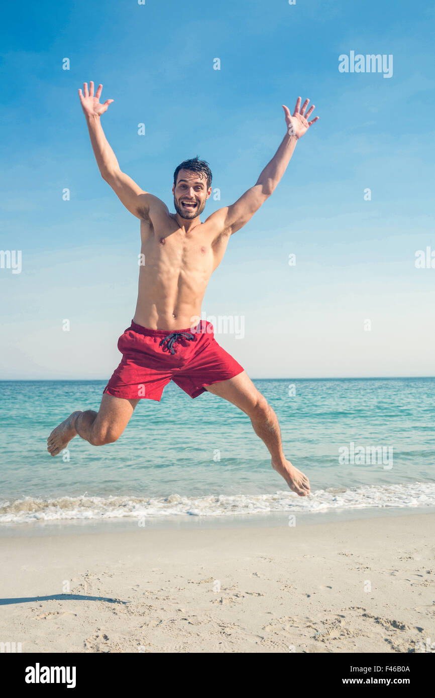 Happy man jumping on the beach Stock Photo Alamy