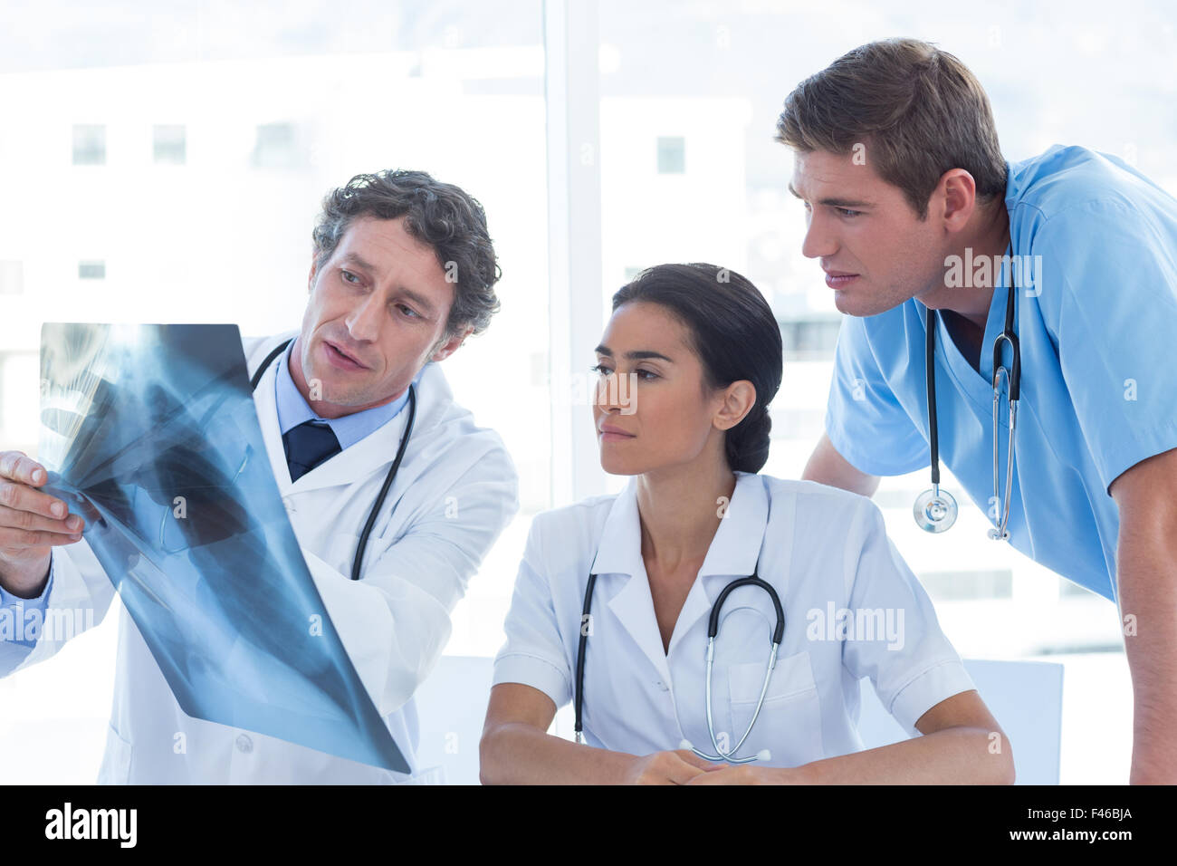 Team of doctors analyzing xray Stock Photo - Alamy