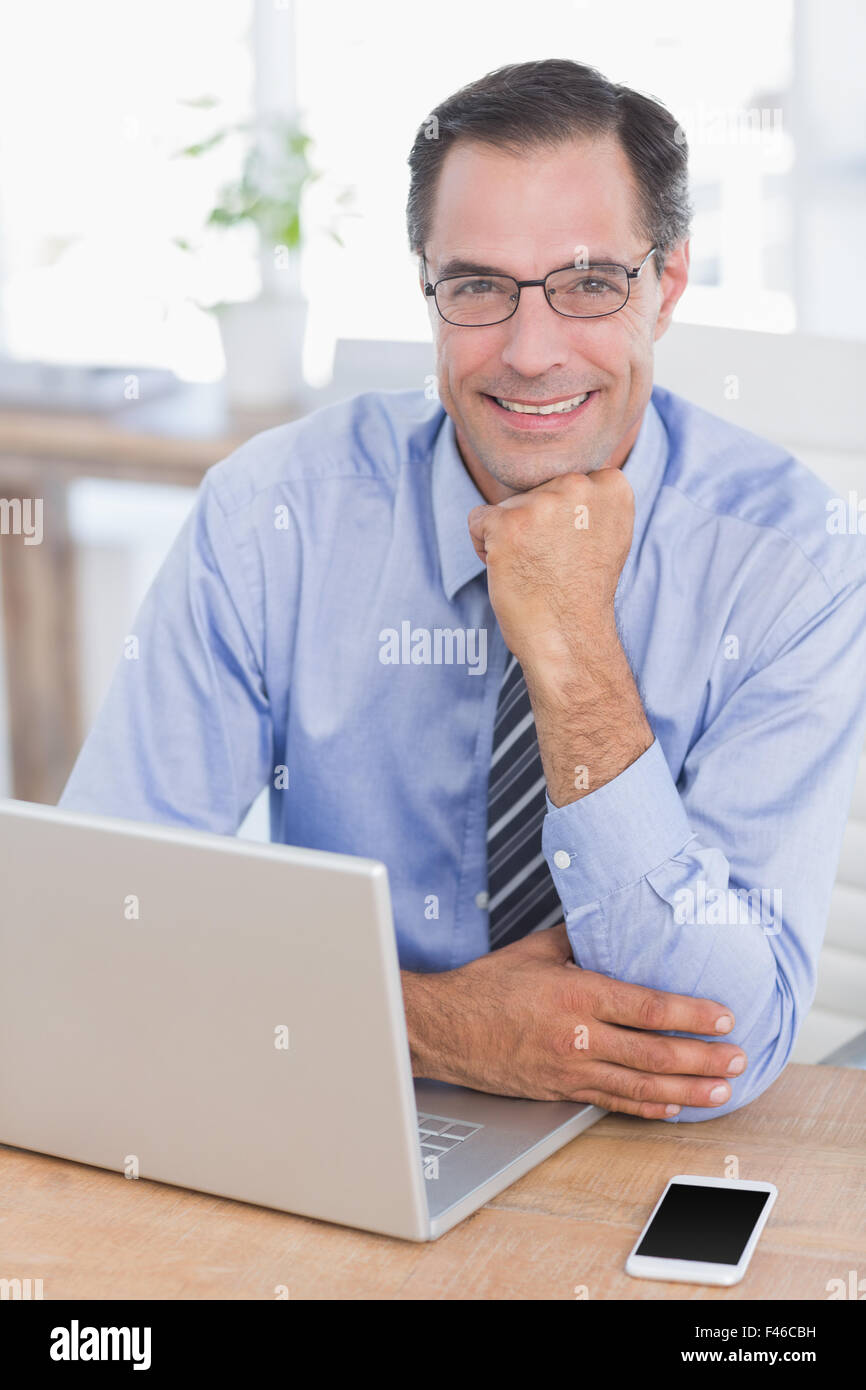 Smiling businessman looking at camera Stock Photo - Alamy
