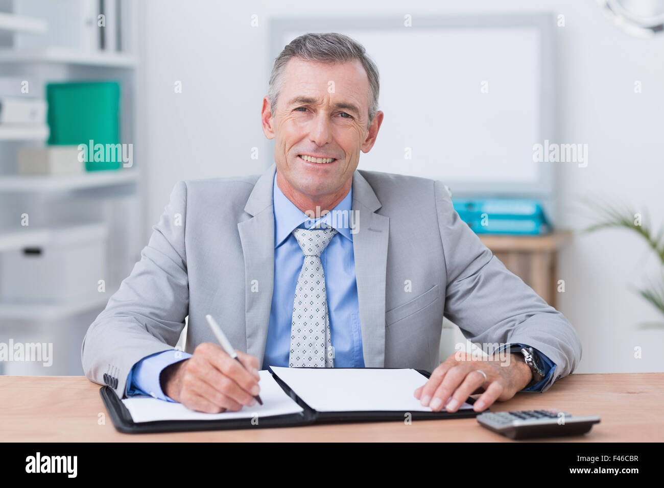 Smiling businessman looking at camera Stock Photo - Alamy