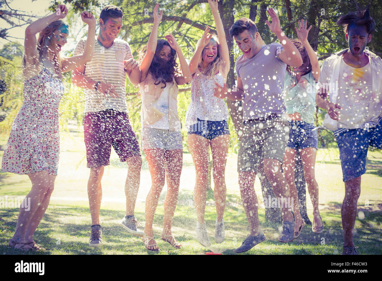 Happy friends jumping in the water shoot Stock Photo - Alamy