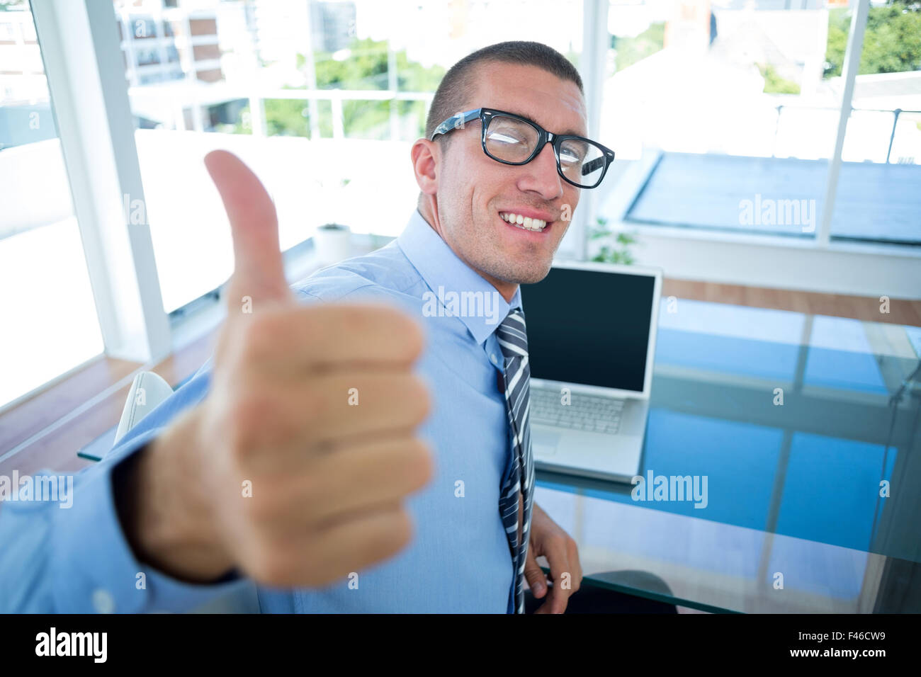 Smiling businessman with thumbs up Stock Photo - Alamy