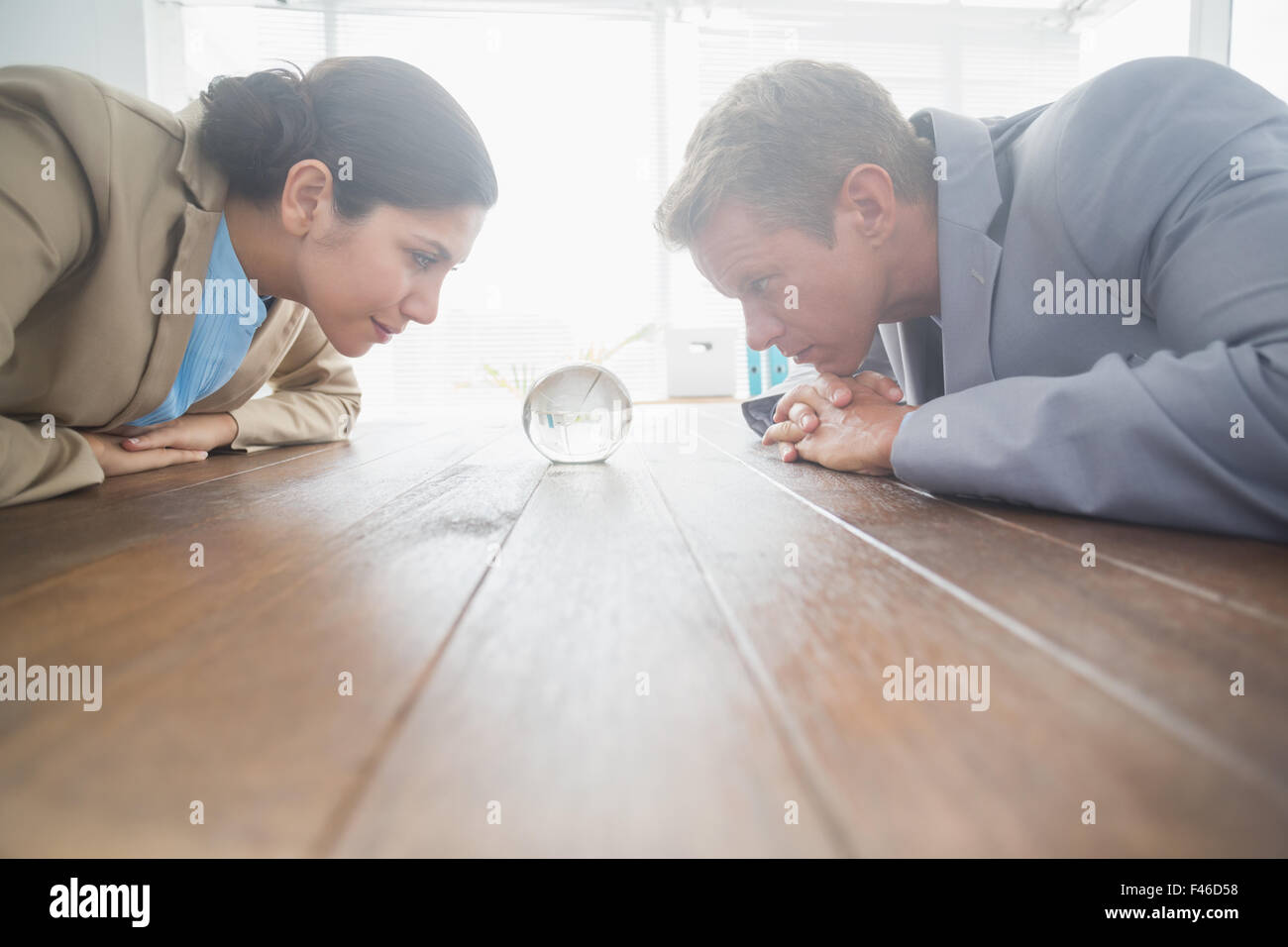 Business partners watching crystal ball Stock Photo - Alamy