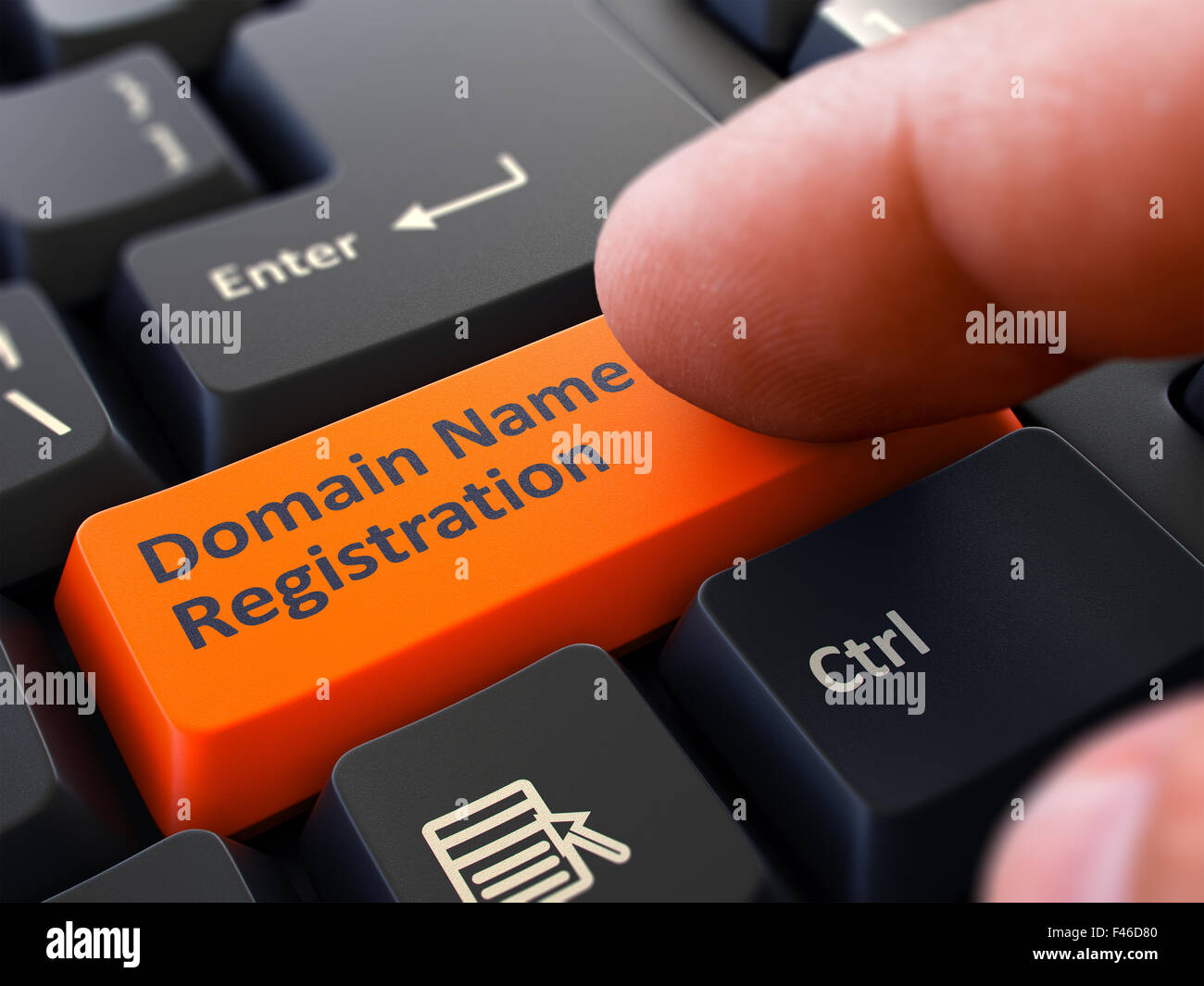 Finger Presses Orange Keyboard Button Domain Name Registration. Stock Photo