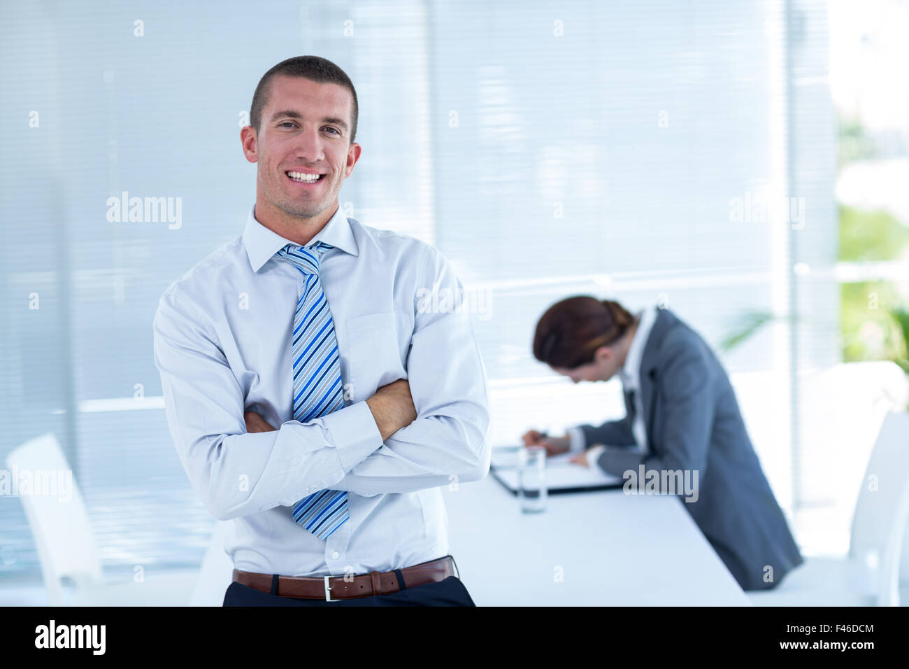 Smiling businessman looking at camera Stock Photo - Alamy