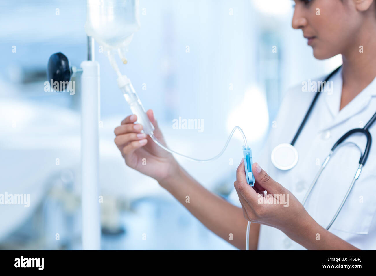 Nurse connecting an intravenous drip Stock Photo