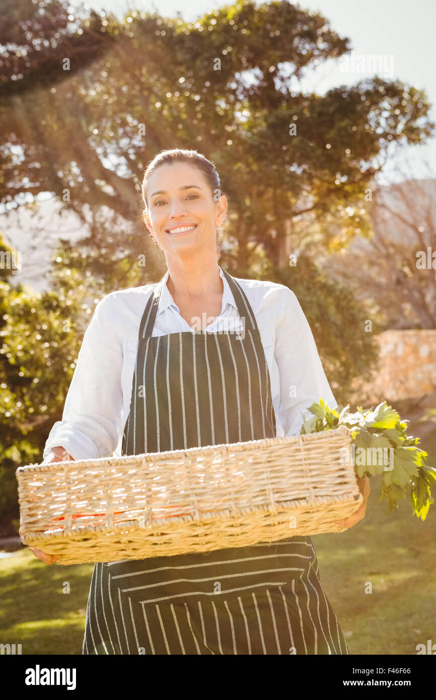 Smiling farmer woman holding a vegetable basket Stock Photo - Alamy