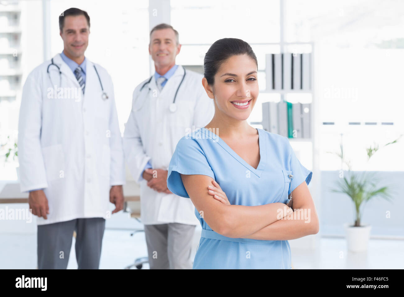 Nurse And Doctors Smiling At Camera Stock Photo - Alamy