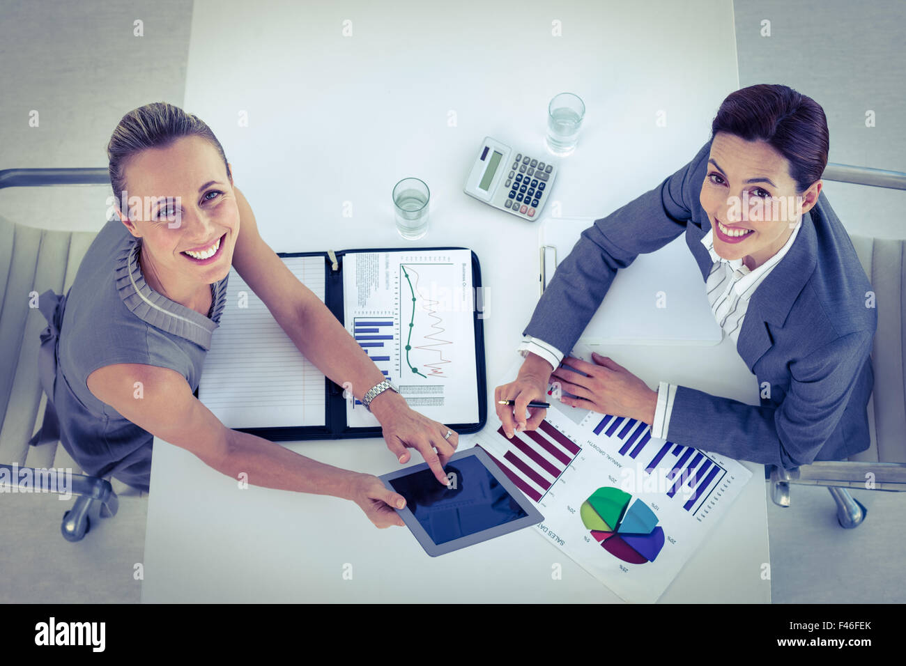 Businesswomen working together at desk Stock Photo - Alamy