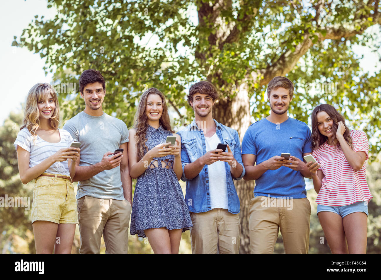 Happy friends in the park Stock Photo - Alamy