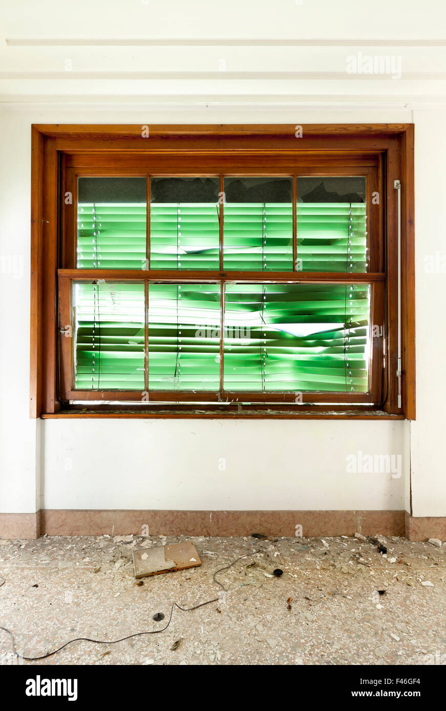 old abandoned house, window with roller shutter broken Stock Photo