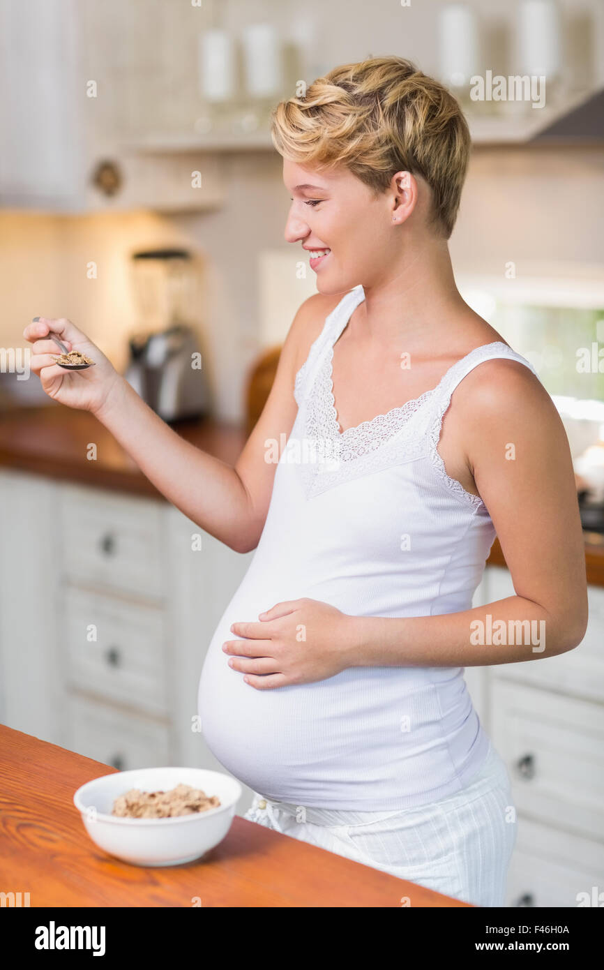 Pregnant woman about to eat cereals Stock Photo Alamy