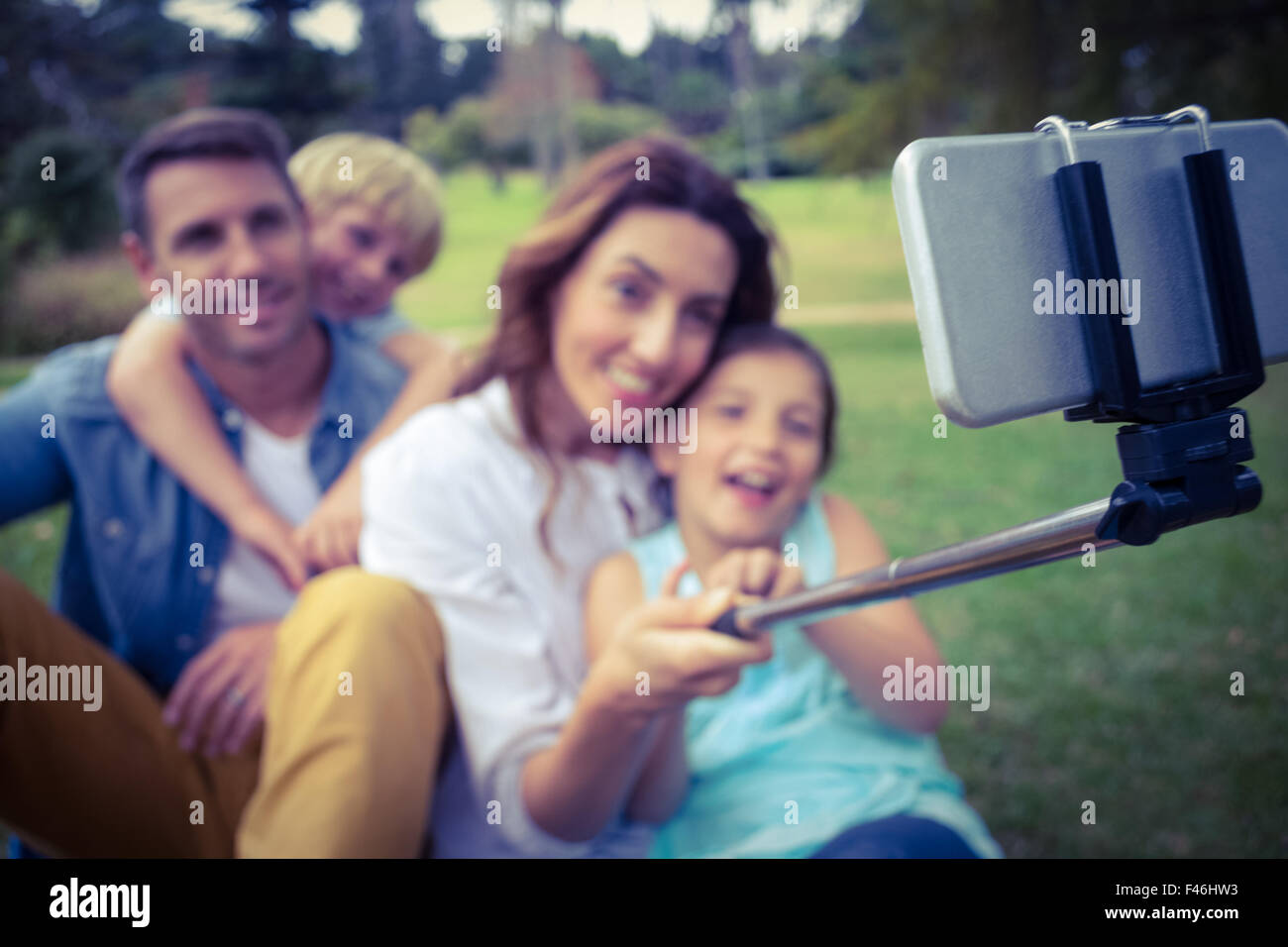 Happy family in the park taking selfie Stock Photo - Alamy