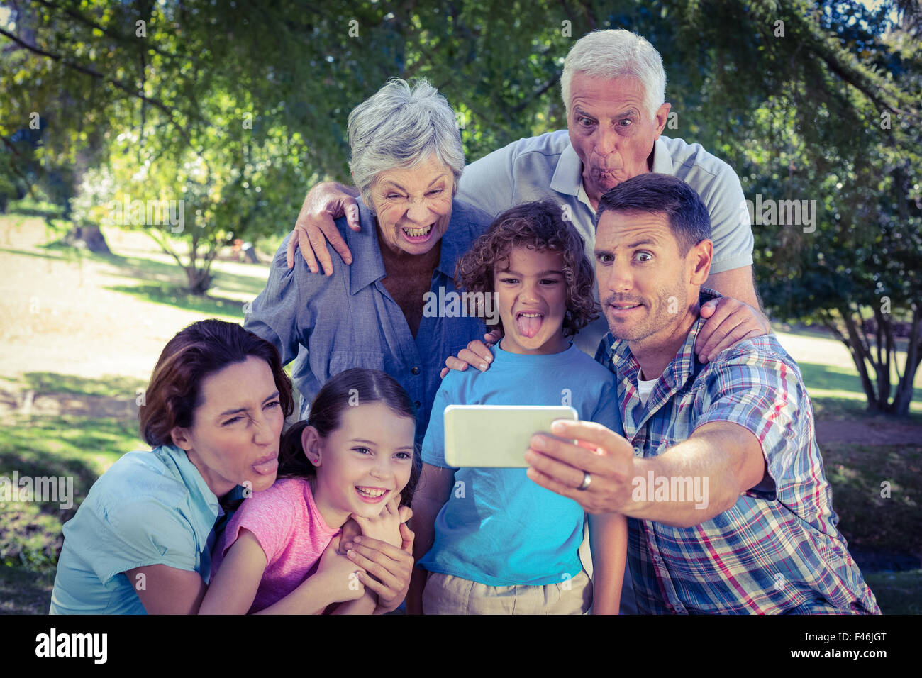 Happy family taking a selfie in the park Stock Photo - Alamy