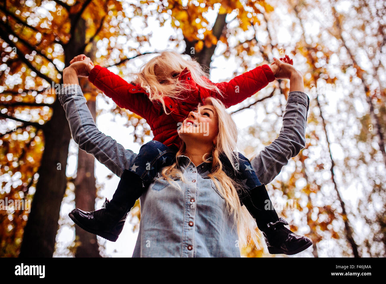 Mother with daughter in autumn park Stock Photo - Alamy