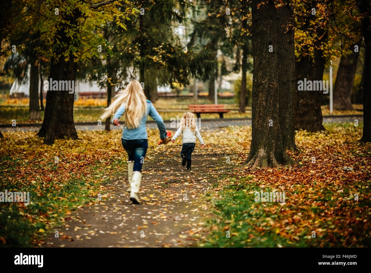 Mother with daughter in autumn park Stock Photo - Alamy