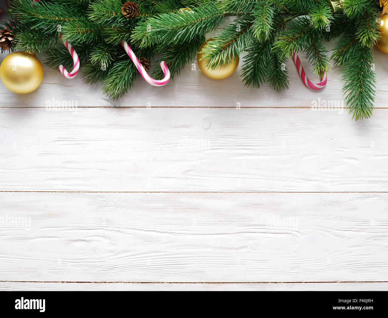 Christmas decoration with fur and baubles on old wood. Stock Photo
